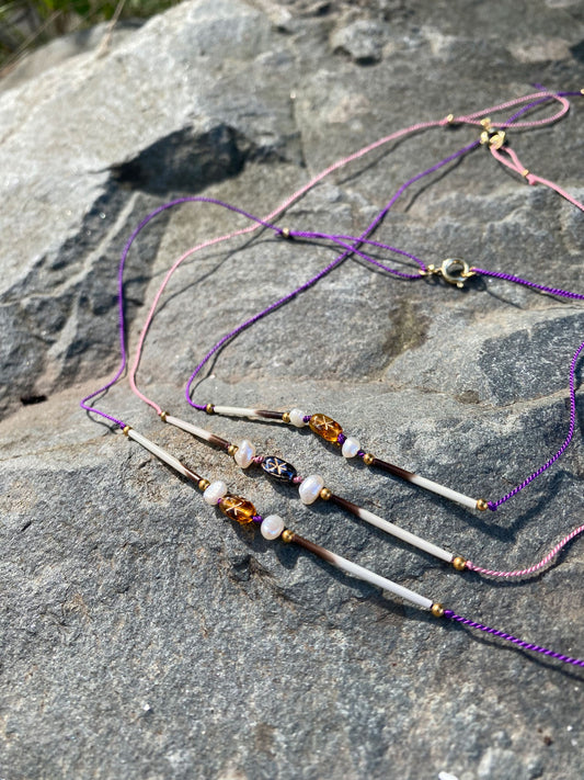 Quill necklace with smoky star bead and pearls on pink cord