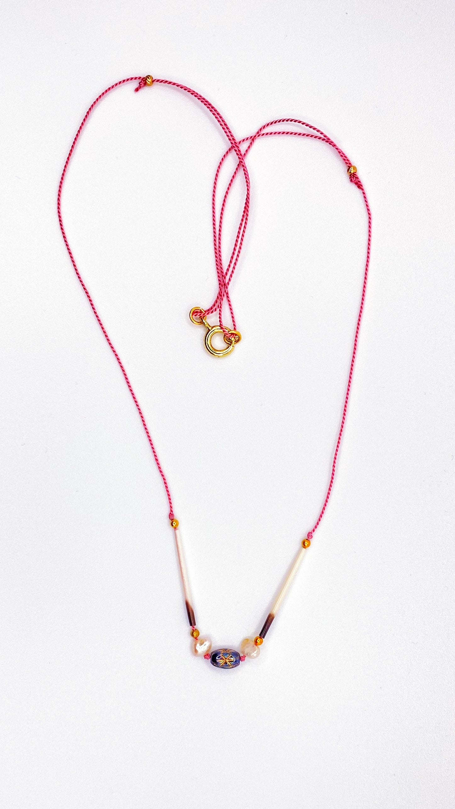 Quill necklace with smoky star bead and pearls on pink cord