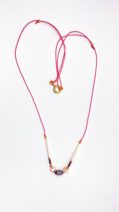 Quill necklace with smoky star bead and pearls on pink cord
